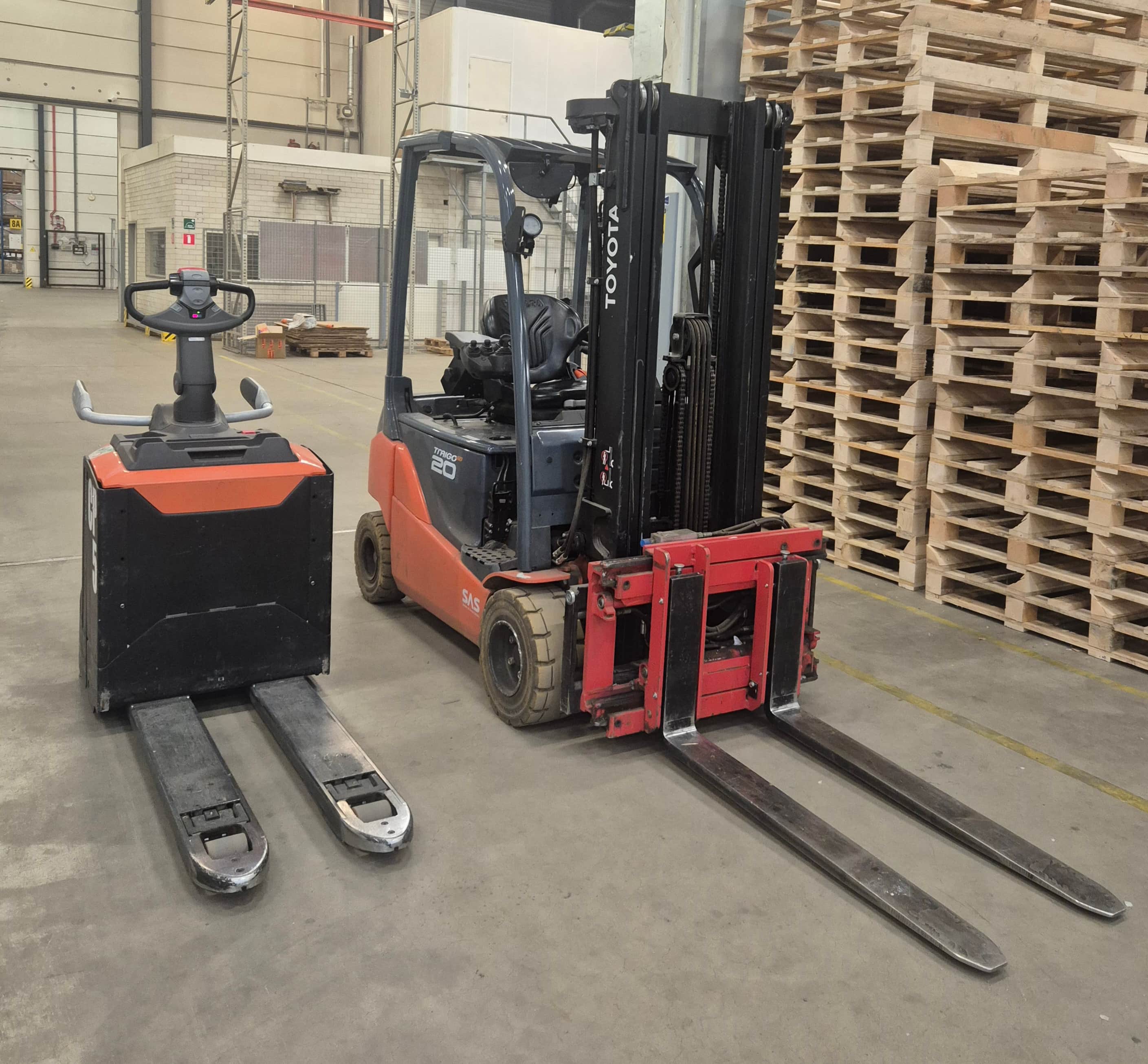 Forklifts loading and unloading in warehouse